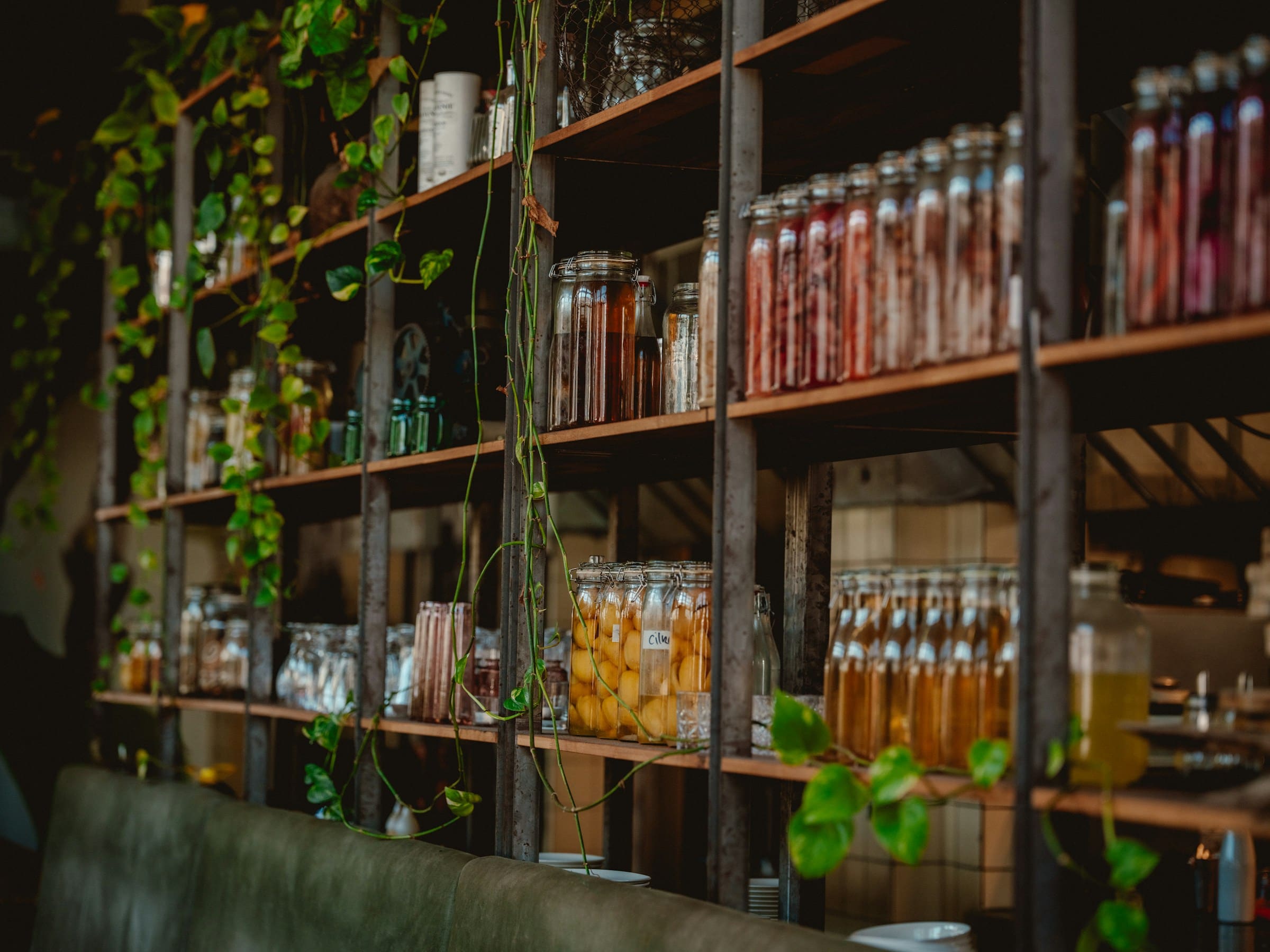 Shelves of jars and preserves in a warm, dim pantry